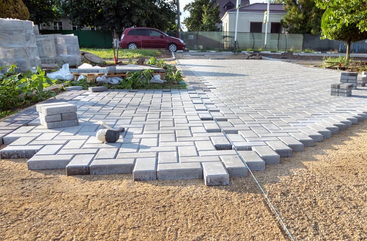 Paver installation in progress at a residential site